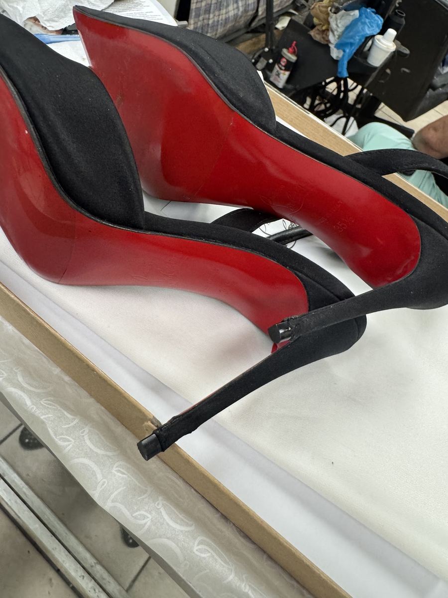 Repaired black heels with red soles